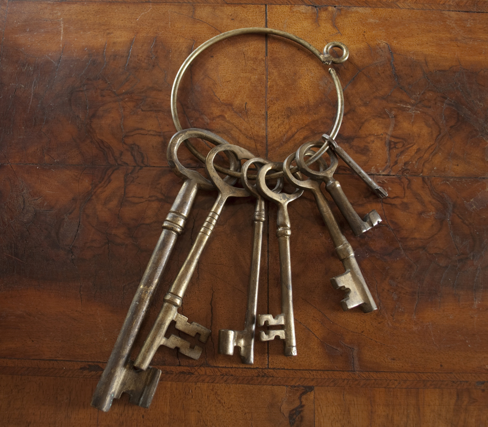 Antique skeleton keys with wood background.